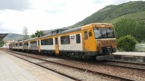 Train driving in the mountains with graffiti 库存影片 65066942