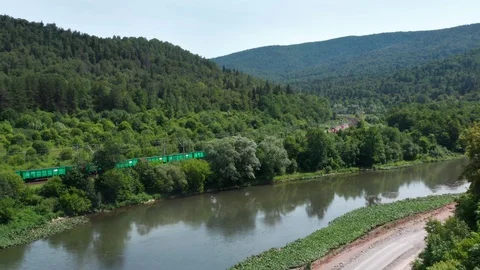 Train.The drone crossing the river and filming the train. 스톡 동영상 112858036