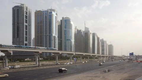Train of the Dubai Metro passing above Sheikh Zayed Road Stock Footage 100741609
