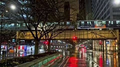 Train on elevated railway above street traffic, quiet evening in Loop, Chicago Stock Footage 305133084