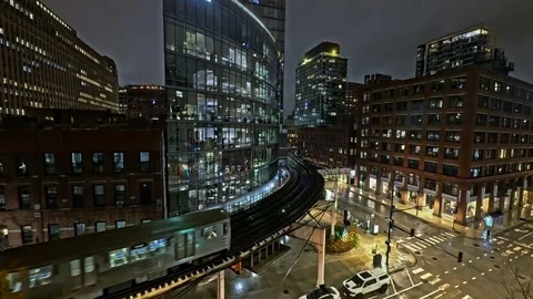 Train on elevated track above the city streets, night in the Loop, Chicago Stock Footage 303812754