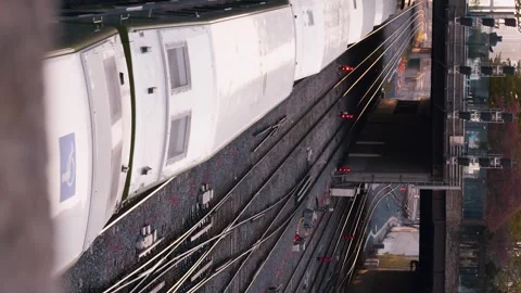 Train emerges from under bridge by tracks New York. path, journey multiple Stock Footage 262546027