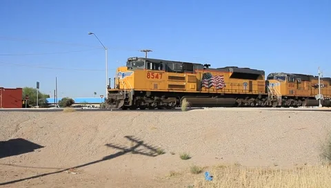Train engine and cars going by on tracks Stock Footage