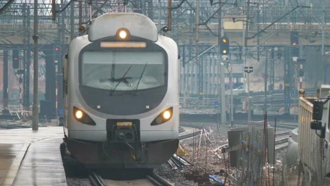 Train entering train station in 4K slow motion Stock Footage 92949938