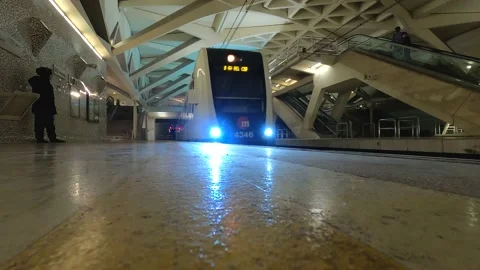 Train entering FROM the tunnel in a station designed by Santiago Calatrava Stock Footage 222941537
