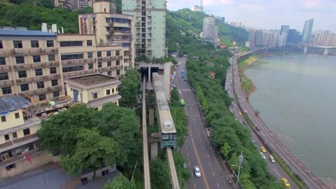 Train enters the station in a residential complex in Chongqing, China Stock Footage 172085707