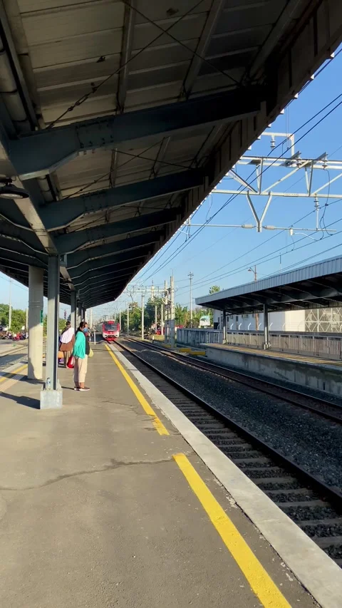 Train in fine weather passing through the station Stock-Footage 270009873