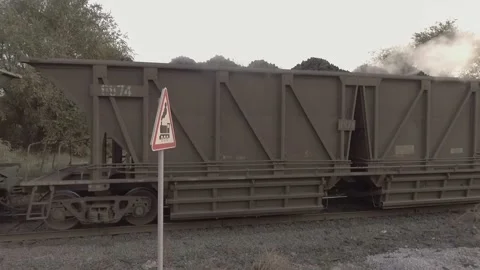 A train with full carriages of hot coal travels along railway lines. Stock-Footage 101782196