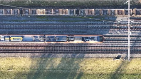 Train Glides Through Zug Railways. Switzerland aerial top down view Stock Footage 264814893