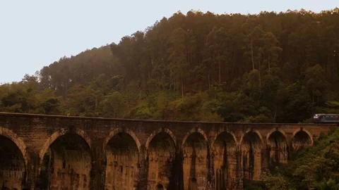 The train goes along the beautiful old bridge Stock Footage 87781434