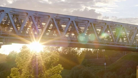 A train goes on a bridge in rays of the sun Stock Footage 103027502