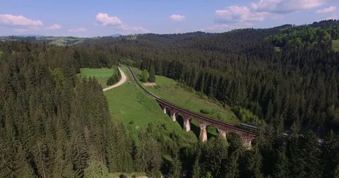 The train goes the old bridge in the Carpathian Mountains Stock Footage 75329882