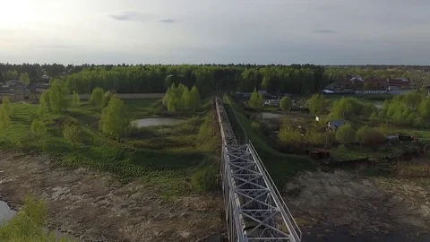 Train goes over the bridge to the forest Stock Footage 75656748