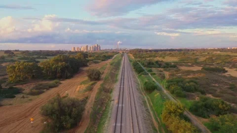 A train goes towards the town Stock Footage 168550007