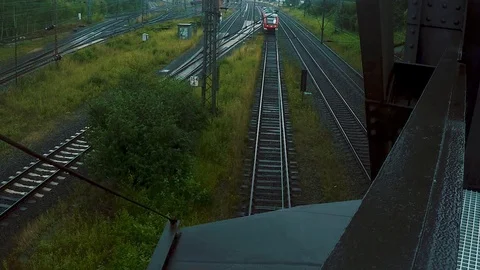 Train goes under a bridge while looking on it from top down Video stock 106556184