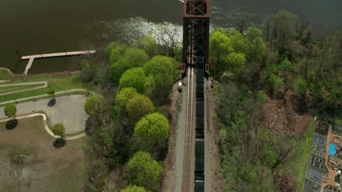 Train going across old rusty bridge over river Stock Footage 152412765