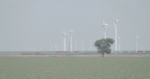 Train Going By in Front of Wind Turbines Windmills Video stock 134363217
