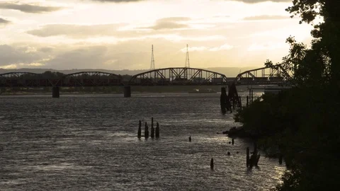 A train going over the rail bridge between Portland and Vancouver near sunset. Stock Footage 77041761