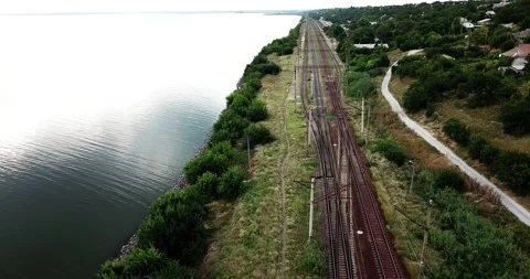 Train going over railway over the river in Ukraine. 4K drone video Stock Footage 137272508