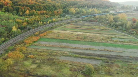 Train going through autumn mountains Stock Footage 124377891