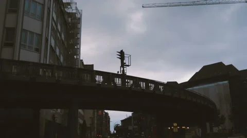 Train going through the curve of a suburban railway bridge in the city of Stock Footage 100109057