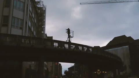 Train going through the curve of a suburban railway bridge in the city of Stock Footage 100109235