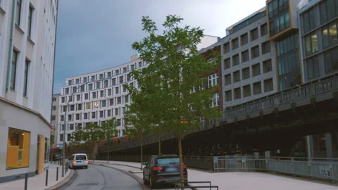 Train going through the curve of a suburban railway bridge in the city of Stock Footage 100109392