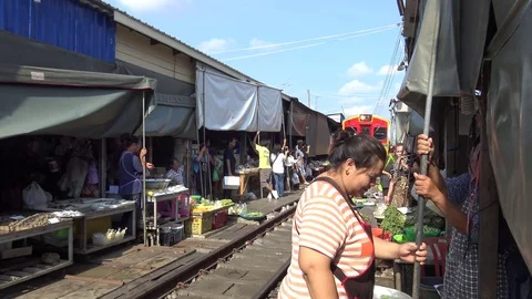 A train is going through the Maeklong Market or Talat Rom Hup. Stock Footage 76489571