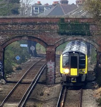 Train Going Under Bridge Stock Photos