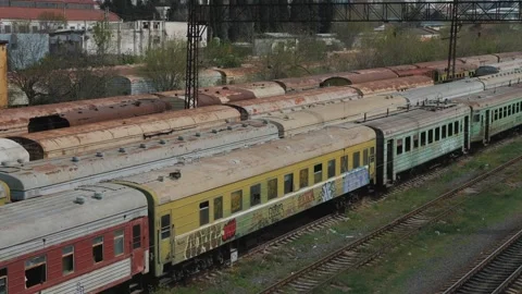 Train graveyard. Lots of old rusty abandoned train cars in Tbilisi Stock Footage 244403206