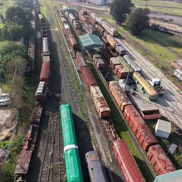 Train graveyard showing abandoned freight cars on railway tracks Stock Photos