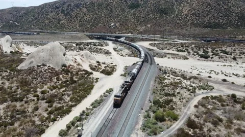 Train heading away Under Highway Video stock 159825480