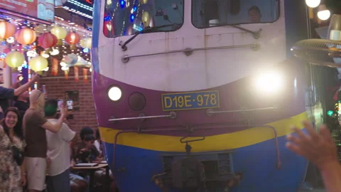 Train Headlights Illuminating Hanoi Train Street Alley. Stock Footage 323771660