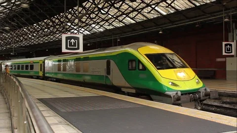 Train Ianrod Eireann idling in station, honks horn, pulls out of station Stock Footage 79694586