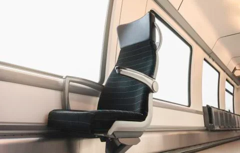 Train interior. Bright train windows and a chair. Train wagon. Stock Photos