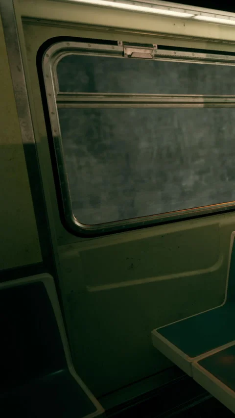 Train interior with empty seats and a view of the outside at sunset Stock Footage 340265487