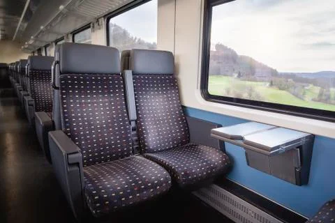 Train interior with empty seats. Swiss modern train wagon Stock Photos