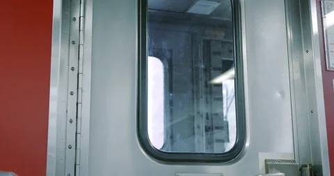 Train Interior with Metal Door and Red Wall Stock Footage 323682435