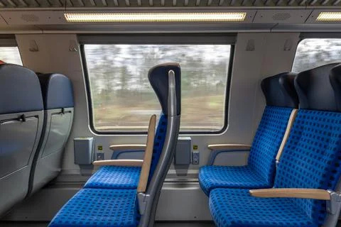 Train interior with rows of seats and window view in motion. Transport trav.. Stock Photos