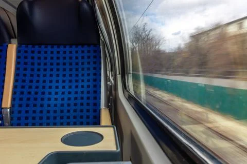 Train interior with seat table and window view in motion. Travel transport .. Stock-Fotos
