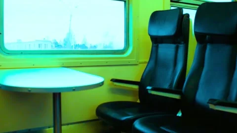 Train interior with seats and table, moving past scenery Stock-Footage 341969717