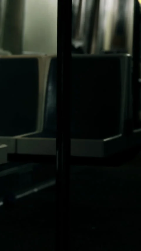 Train interior shows empty seats and window reflections at night Stock Footage 331685765