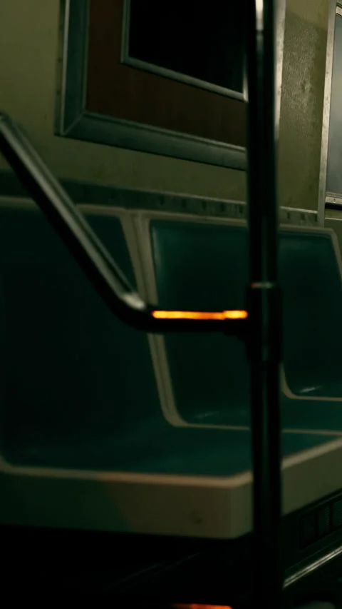 Train interior shows empty seats and handle in subway during late night Stock Footage 339100169