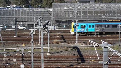 Train itavelling through a train yard Stock Footage 94211923