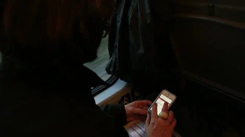 Train journey, Iphone used (hidden face) Stock Footage 34487007