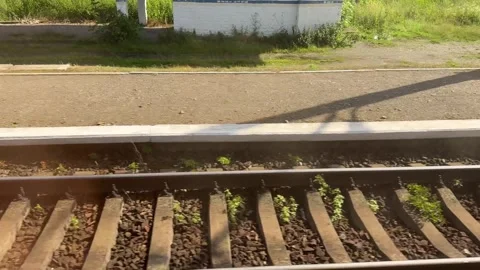 Train journey passing through rural landscapes and small stations Stock Footage 313433598