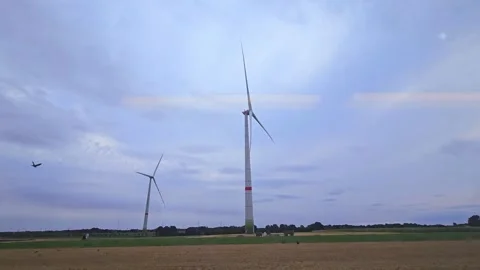 Train Journey Passing Wind Turbines in Open Field Landscape Stock Footage 344704963