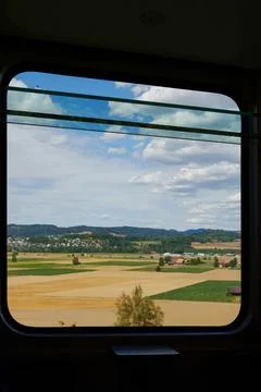 Train journey view, capturing swiss countryside landscape from a railway window Stock Photos