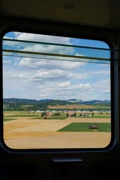 Train journey view, capturing swiss countryside landscape from a railway window Stock Photos