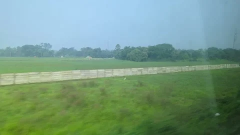 Train Journey View of Green Fields Through Window while travelling in India Stock Footage 304115592